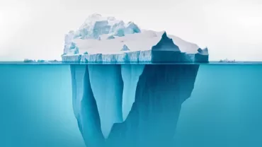 Large iceberg floating, with visible underwater mass.