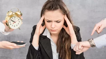 Person looking stressed with multiple tasks and a clock around them.
